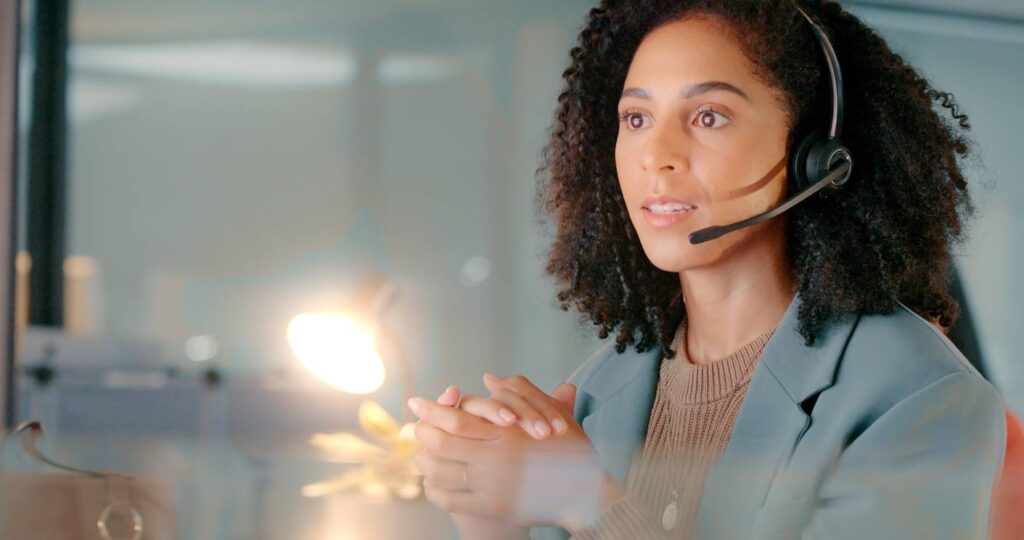call center black woman with crm and working in customer service consulting with customer headset and phone call conversation contact us customer support and help on call online and consultant