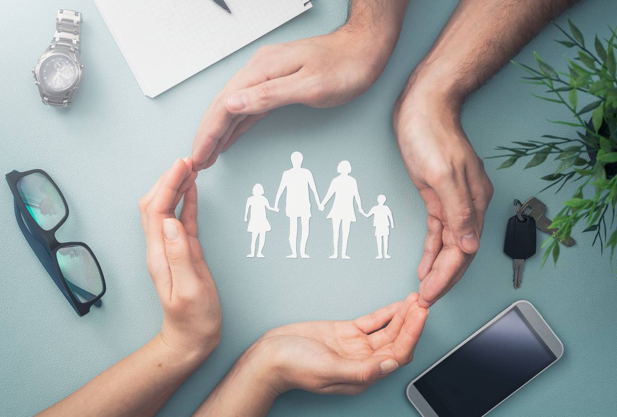 may 7,, hands with cut out paper silhouette on table family care concept