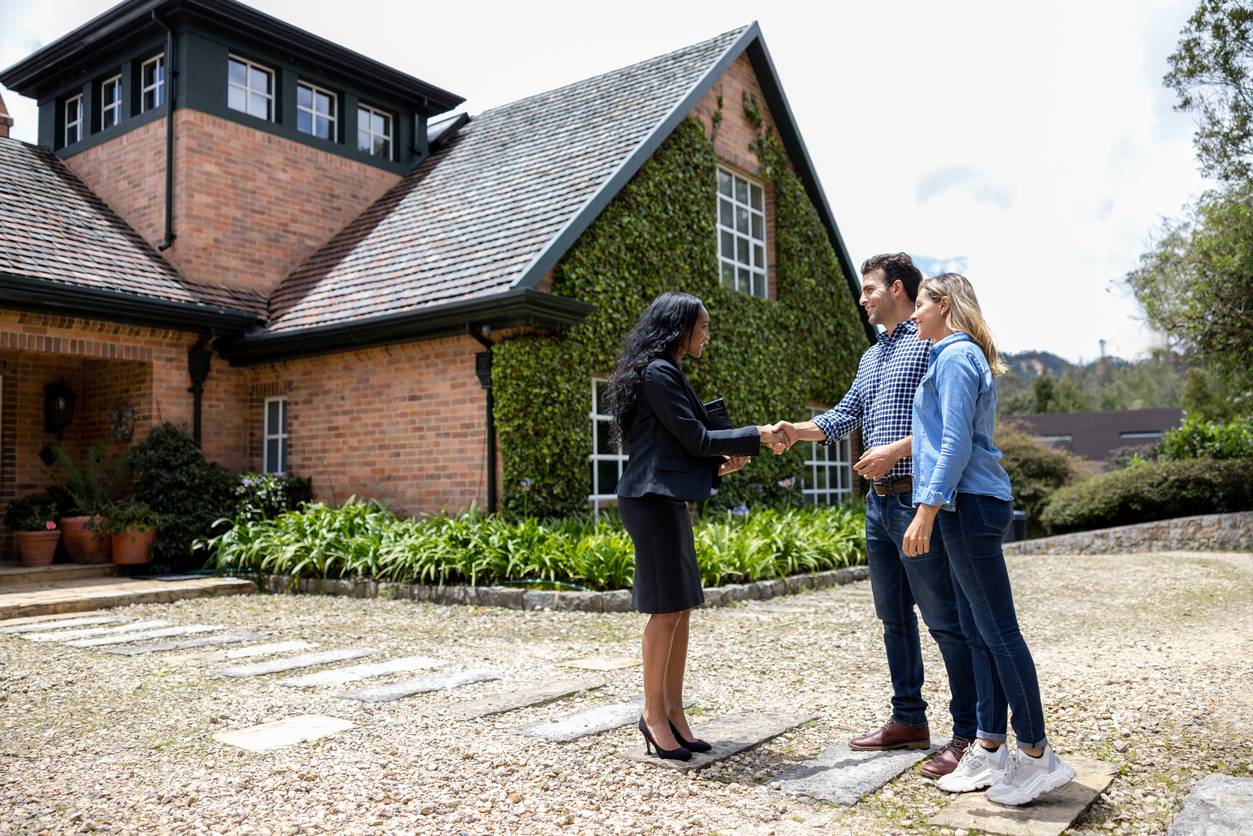 boost tenant retention with proven property strategies, happy real estate agent meeting a couple for a house showing and greeting them with a handshake
