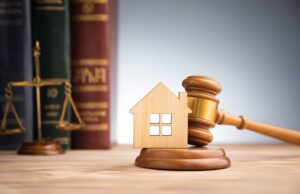judge auction and real estate concept house model gavel and law books