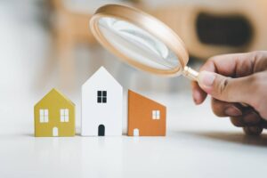 magnifying glass and house model house selection real estate concept