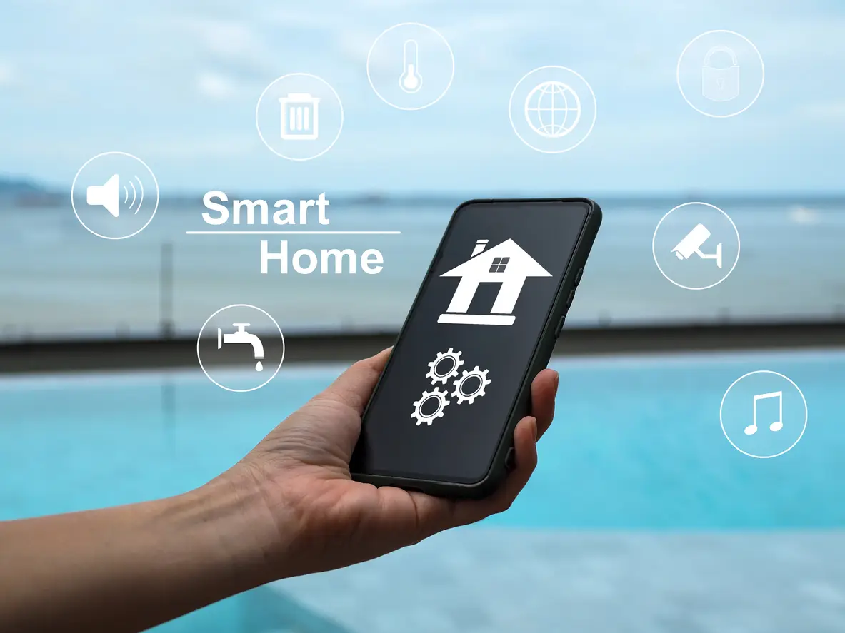 Smartphone displaying smart home interface with icons for security, water, and sound control, set against a poolside background, highlighting modern technology for rental properties.