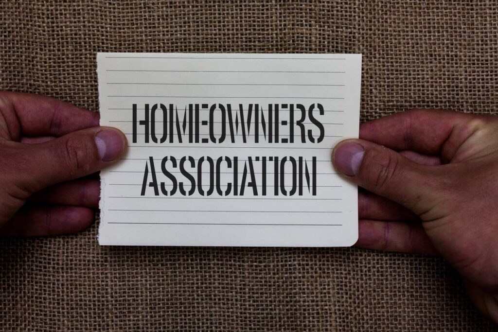 mastering hoa meetings: key tips for property success, text sign showing homeowners association conceptual photo organization with fee for upkeeps of gated community man holding piece notebook paper jute background communicating ideas