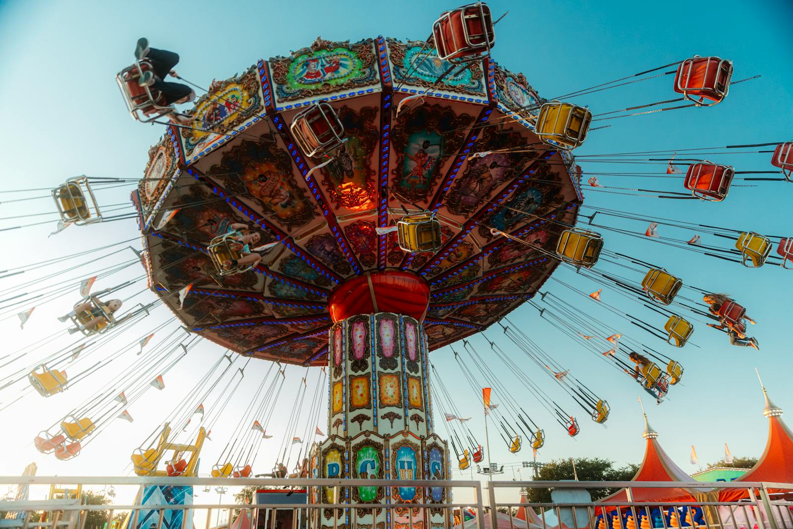Colorful swing ride spinning at an amusement park in Costa Mesa, California.